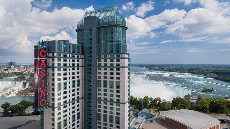 Fallsview Casino Resort — tower overlooking the illuminated Horseshoe Falls with the red CASINO sign.