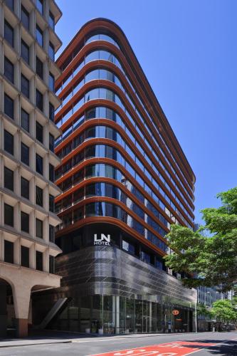Little National Hotel Sydney — LN HOTEL building with copper bands and curved glass facade.