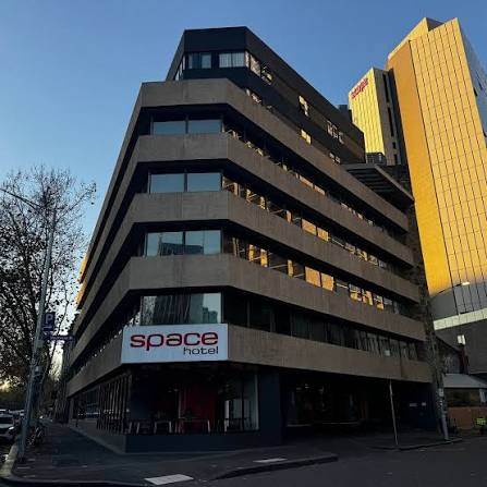 Space Hotel, Melbourne — corner building with space hotel signage on a city street.