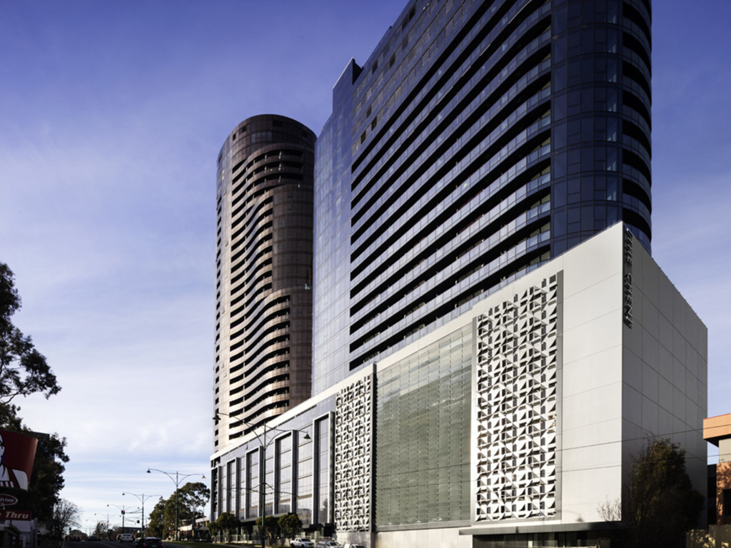 The Chen, Box Hill — twin-tower art hotel with copper-toned cylindrical tower and THE CHEN signage.