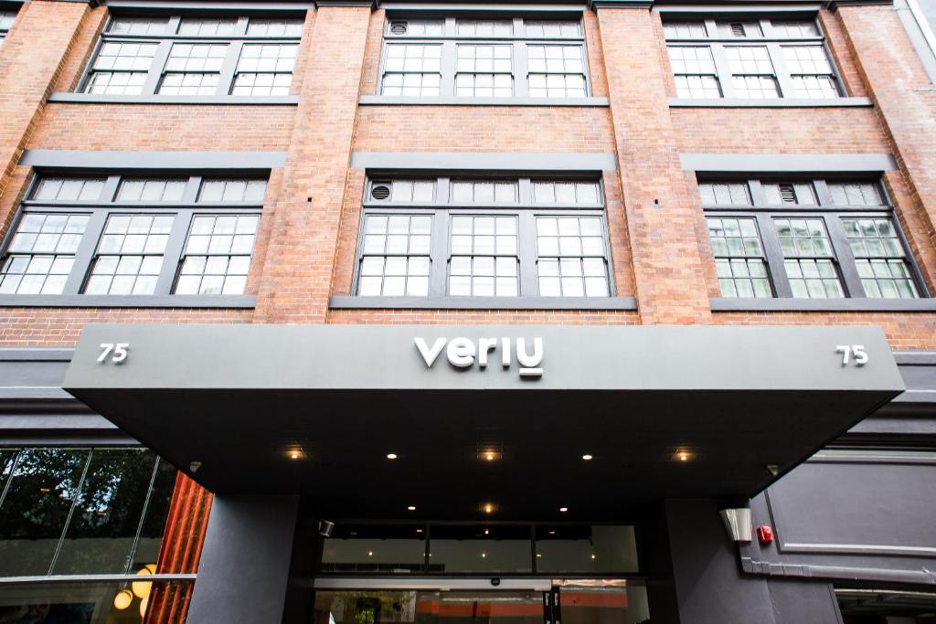 Veriu Central, Surry Hills — warm industrial micro-studio with exposed brick, integrated kitchenette and clever storage wall.